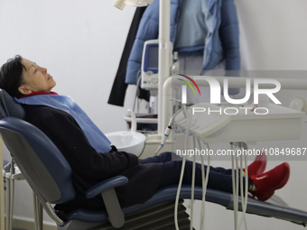 An older adult is sitting inside the Centro de Odontogeriatria TIII Doctor Guillermo Roman y Carrillo Dental Clinic in Iztapalapa, Mexico Ci...