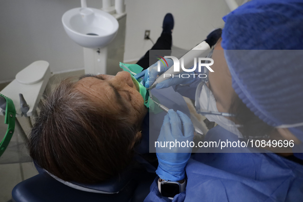 A dentist at the Centro de Salud TIII Doctor Guillermo Roman y Carrillo in the Iztapalapa district of Mexico City is attending to an older a...