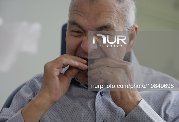 An older adult is being fitted with a dental prosthesis at the Centro de Odontogeriatria Centro de Salud TIII Doctor Guillermo Roman y Carri...