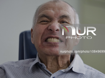 An older adult is smiling after having a dental prosthesis fitted at the Centro de Salud TIII Doctor Guillermo Roman y Carrillo Dental Clini...