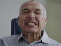 An older adult is smiling after having a dental prosthesis fitted at the Centro de Salud TIII Doctor Guillermo Roman y Carrillo Dental Clini...