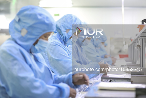 Workers are making medical infusion sets for export in a workshop in Huai'an City, Jiangsu Province, China, on December 14, 2023. 