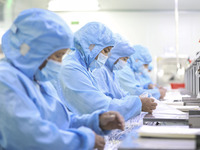 Workers are making medical infusion sets for export in a workshop in Huai'an City, Jiangsu Province, China, on December 14, 2023. (