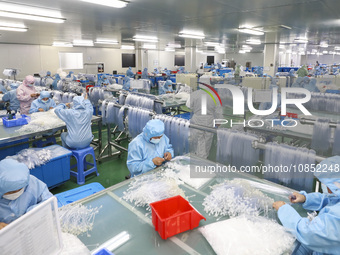 Workers are making medical infusion sets for export at a workshop in Huai'an City, Jiangsu Province, China, on December 14, 2023. (