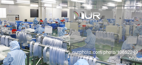 Workers are making medical infusion sets for export at a workshop in Huai'an City, Jiangsu Province, China, on December 14, 2023. 