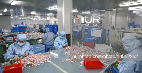 Workers are making medical infusion sets for export at a workshop in Huai'an City, Jiangsu Province, China, on December 14, 2023. 