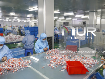 Workers are making medical infusion sets for export at a workshop in Huai'an City, Jiangsu Province, China, on December 14, 2023. (