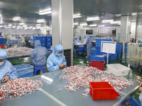 Workers are making medical infusion sets for export at a workshop in Huai'an City, Jiangsu Province, China, on December 14, 2023. (