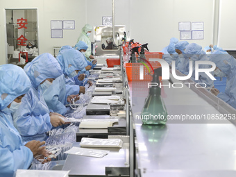 Workers are making medical infusion sets for export in a workshop in Huai'an City, Jiangsu Province, China, on December 14, 2023. (