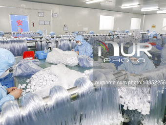 Workers are making medical infusion sets for export at a workshop in Huai'an City, Jiangsu Province, China, on December 14, 2023. (