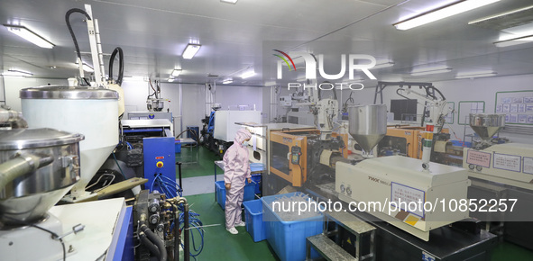 Workers are making medical infusion sets for export at a workshop in Huai'an City, Jiangsu Province, China, on December 14, 2023. 