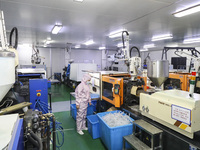 Workers are making medical infusion sets for export at a workshop in Huai'an City, Jiangsu Province, China, on December 14, 2023. (