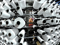 A worker is rushing to complete an order at a woven bag production workshop in Lianyungang, Jiangsu Province, China, on December 15, 2023. (