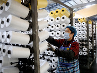 A worker is rushing to complete an order at a woven bag production workshop in Lianyungang, Jiangsu Province, China, on December 15, 2023. (