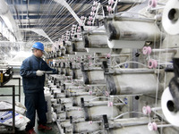 A worker is rushing to complete an order at a woven bag production workshop in Lianyungang, Jiangsu Province, China, on December 15, 2023. (