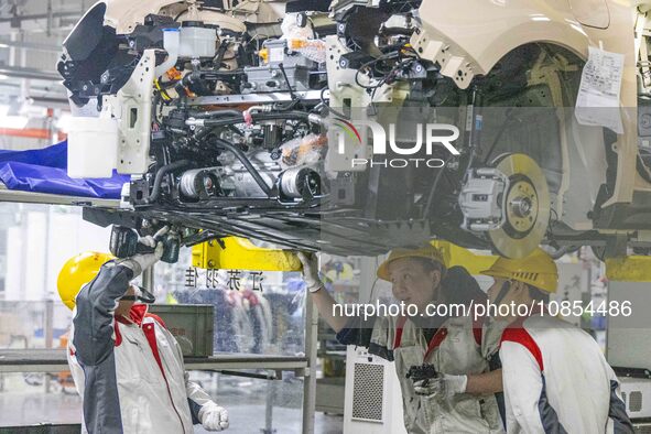 A worker is working at the production workshop of Great Wall Motor's Taizhou Smart Factory in Taizhou, Jiangsu Province, China, on December...