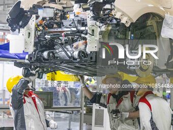 A worker is working at the production workshop of Great Wall Motor's Taizhou Smart Factory in Taizhou, Jiangsu Province, China, on December...