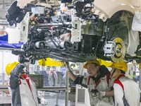 A worker is working at the production workshop of Great Wall Motor's Taizhou Smart Factory in Taizhou, Jiangsu Province, China, on December...