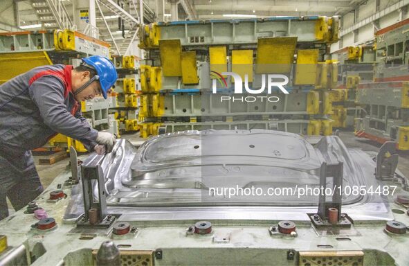 A worker is working at the production workshop of Great Wall Motor's Taizhou Smart Factory in Taizhou, Jiangsu Province, China, on December...