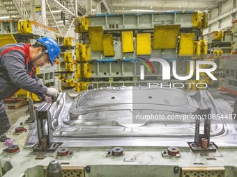 A worker is working at the production workshop of Great Wall Motor's Taizhou Smart Factory in Taizhou, Jiangsu Province, China, on December...