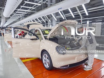 A worker is working at the production workshop of Great Wall Motor's Taizhou Smart Factory in Taizhou, Jiangsu Province, China, on December...