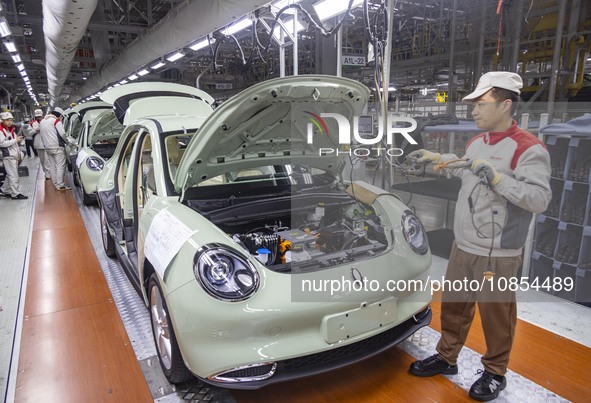 A worker is working at the production workshop of Great Wall Motor's Taizhou Smart Factory in Taizhou, Jiangsu Province, China, on December...