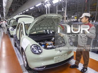 A worker is working at the production workshop of Great Wall Motor's Taizhou Smart Factory in Taizhou, Jiangsu Province, China, on December...