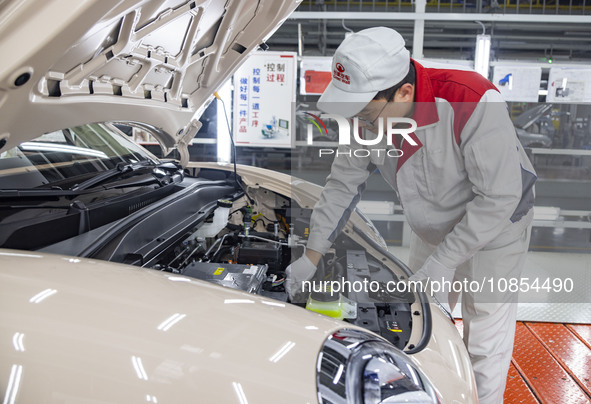 A worker is working at the production workshop of Great Wall Motor's Taizhou Smart Factory in Taizhou, Jiangsu Province, China, on December...