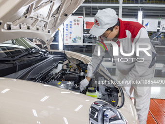 A worker is working at the production workshop of Great Wall Motor's Taizhou Smart Factory in Taizhou, Jiangsu Province, China, on December...