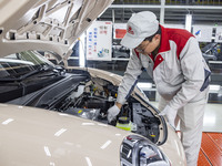 A worker is working at the production workshop of Great Wall Motor's Taizhou Smart Factory in Taizhou, Jiangsu Province, China, on December...