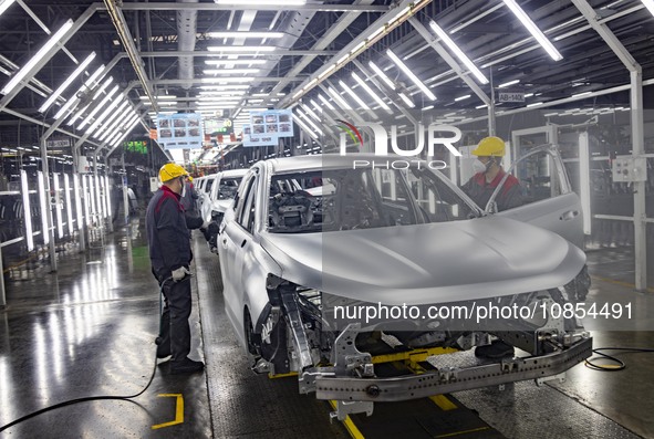 A worker is working at the production workshop of Great Wall Motor's Taizhou Smart Factory in Taizhou, Jiangsu Province, China, on December...