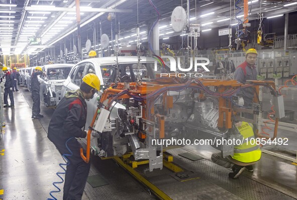 A worker is working at the production workshop of Great Wall Motor's Taizhou Smart Factory in Taizhou, Jiangsu Province, China, on December...