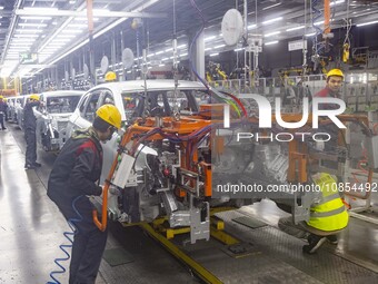 A worker is working at the production workshop of Great Wall Motor's Taizhou Smart Factory in Taizhou, Jiangsu Province, China, on December...