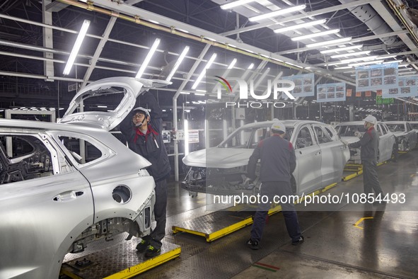 A worker is working at the production workshop of Great Wall Motor's Taizhou Smart Factory in Taizhou, Jiangsu Province, China, on December...