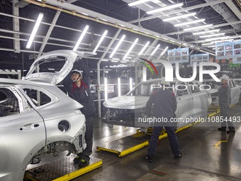 A worker is working at the production workshop of Great Wall Motor's Taizhou Smart Factory in Taizhou, Jiangsu Province, China, on December...