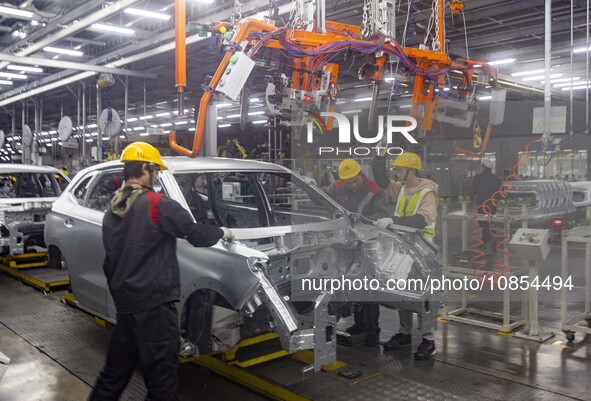 A worker is working at the production workshop of Great Wall Motor's Taizhou Smart Factory in Taizhou, Jiangsu Province, China, on December...