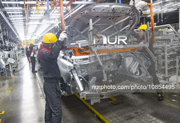 A worker is working at the production workshop of Great Wall Motor's Taizhou Smart Factory in Taizhou, Jiangsu Province, China, on December...