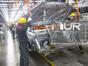 A worker is working at the production workshop of Great Wall Motor's Taizhou Smart Factory in Taizhou, Jiangsu Province, China, on December...