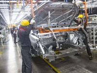 A worker is working at the production workshop of Great Wall Motor's Taizhou Smart Factory in Taizhou, Jiangsu Province, China, on December...