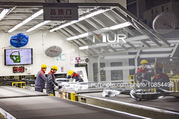 A worker is working at the production workshop of Great Wall Motor's Taizhou Smart Factory in Taizhou, Jiangsu Province, China, on December...