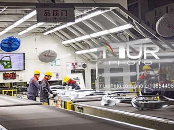 A worker is working at the production workshop of Great Wall Motor's Taizhou Smart Factory in Taizhou, Jiangsu Province, China, on December...