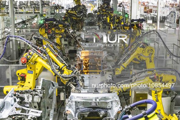 A robot is performing welding operations at the production workshop of Great Wall Motor's Taizhou Smart Factory in Taizhou, Jiangsu province...