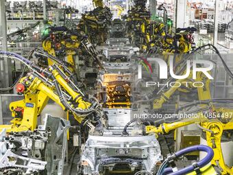 A robot is performing welding operations at the production workshop of Great Wall Motor's Taizhou Smart Factory in Taizhou, Jiangsu province...