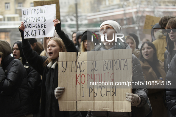 An activist is holding a placard during a rally to demand increased financial support for the Armed Forces of Ukraine outside the Kyiv City...