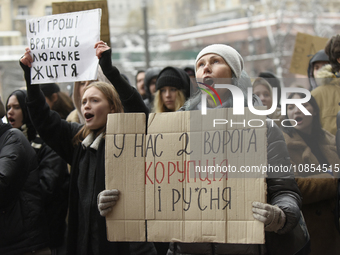 An activist is holding a placard during a rally to demand increased financial support for the Armed Forces of Ukraine outside the Kyiv City...