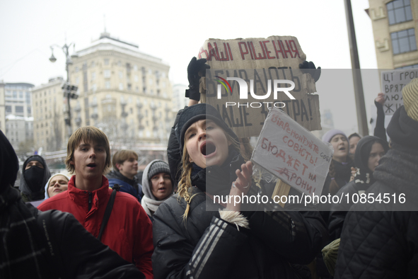 Demonstrators are holding placards as they demand an increase in financial support for the Armed Forces of Ukraine outside the Kyiv City Sta...