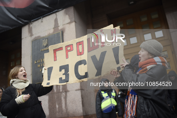 Demonstrators are holding placards as they demand an increase in financial support for the Armed Forces of Ukraine outside the Kyiv City Sta...