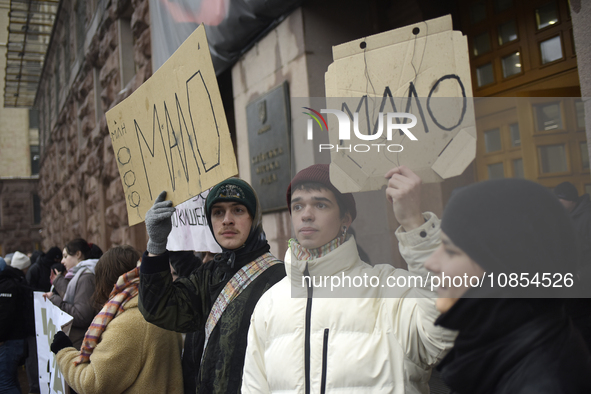 Demonstrators are holding placards as they demand an increase in financial support for the Armed Forces of Ukraine outside the Kyiv City Sta...