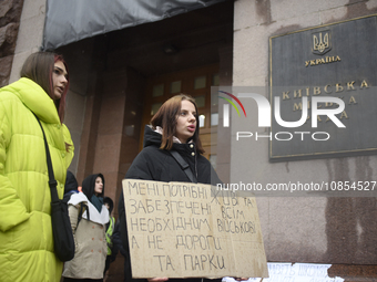 Demonstrators are holding placards as they demand an increase in financial support for the Armed Forces of Ukraine outside the Kyiv City Sta...