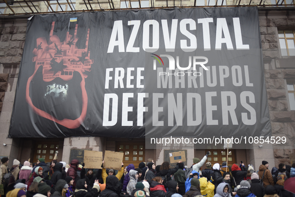 Demonstrators are holding placards as they demand an increase in financial support for the Armed Forces of Ukraine outside the Kyiv City Sta...